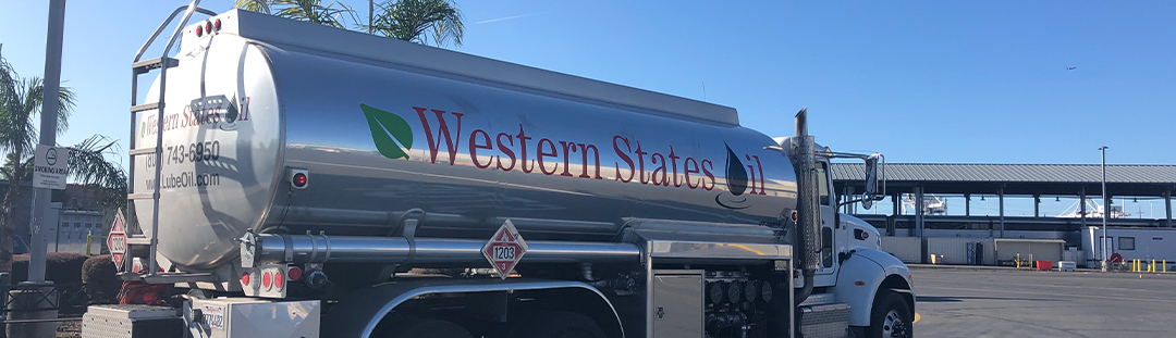 A silver truck parked in a parking lot.