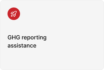 A red circular icon with a white rocket above the text "GHG reporting assistance" on a plain background.